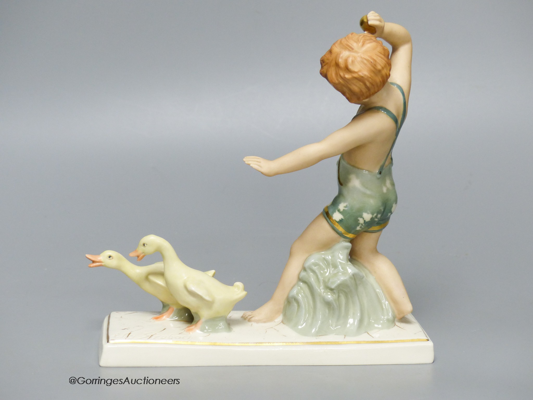 A Royal Dux group of a boy with ducks, 18cm tall